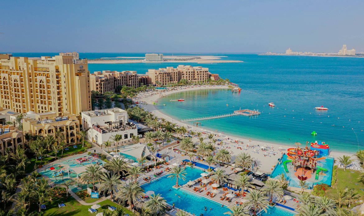 Marjan Beach in Ras Al Khaimah with clear blue water and sandy shoreline